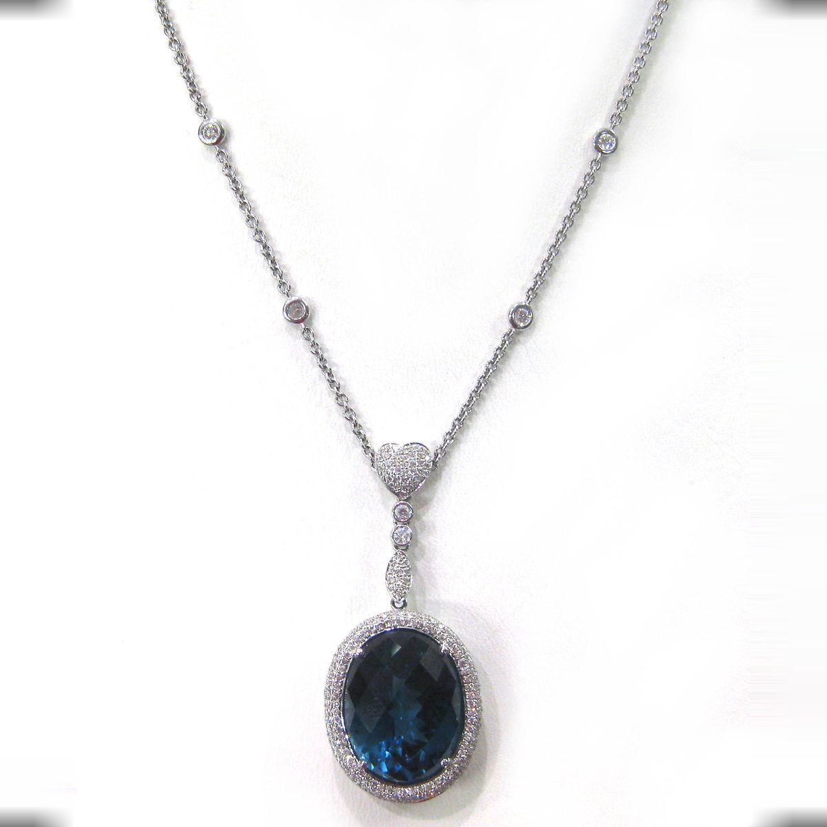 London blue topaz pendant necklace with a pave diamond halo and heart accent