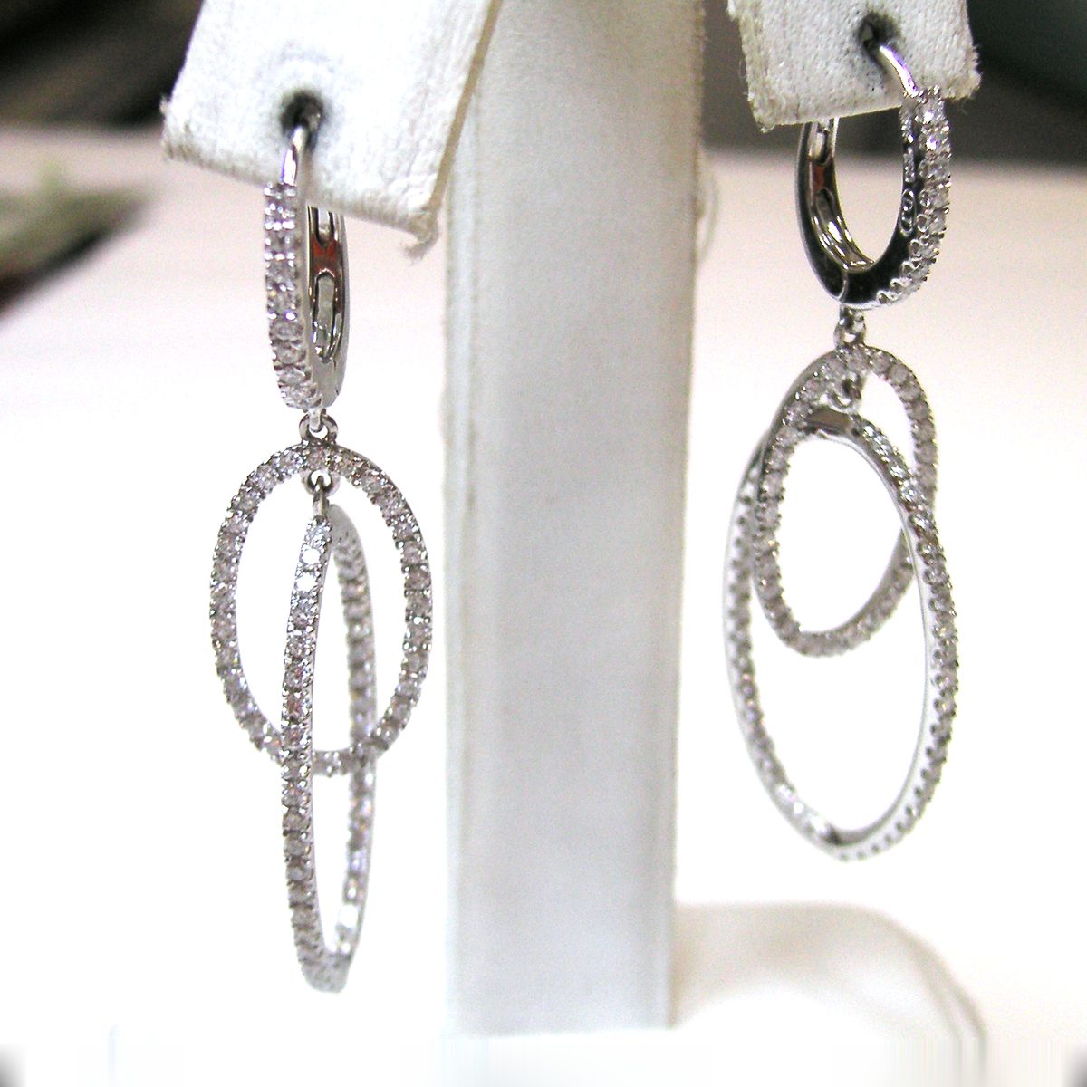 White gold dangle earrings with interlocking pave diamond ovals